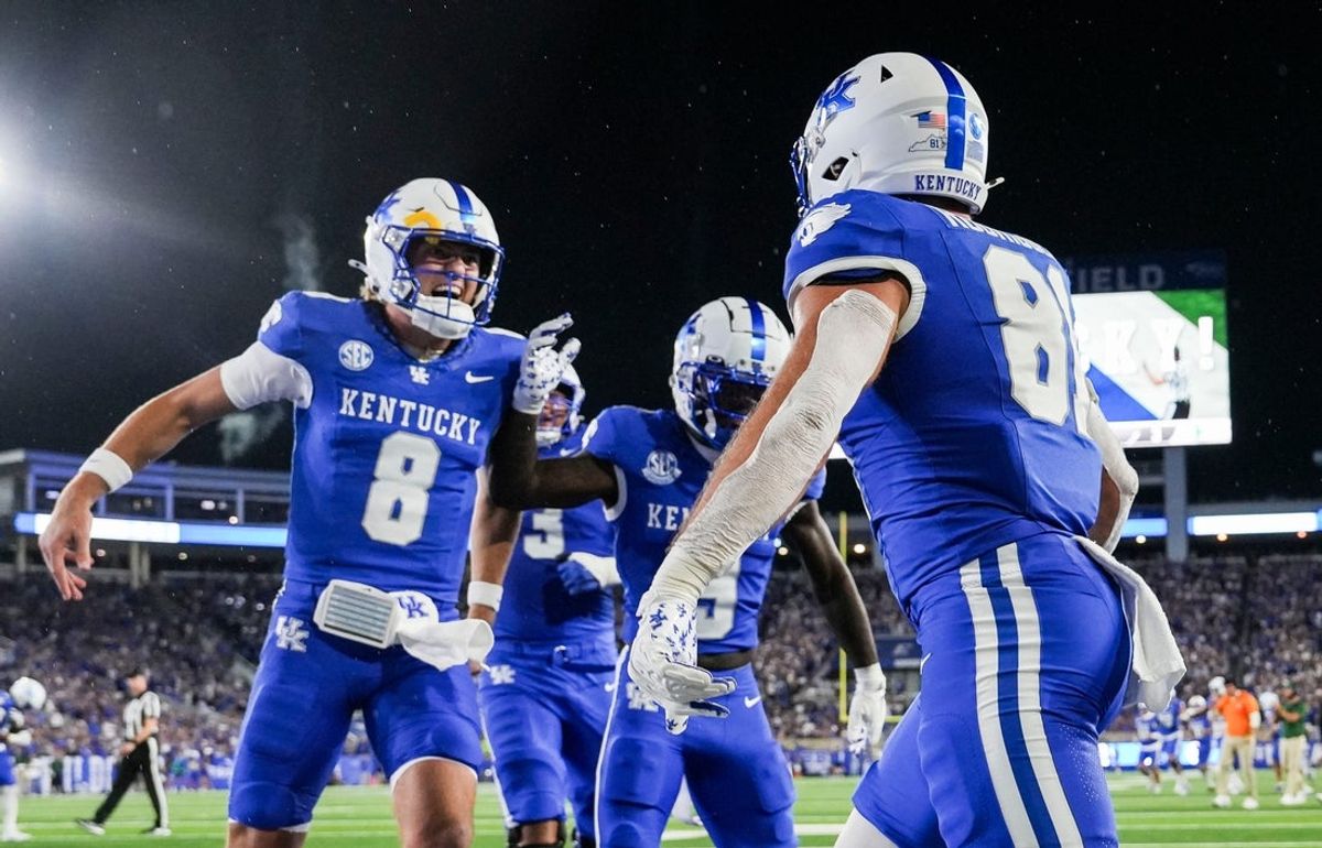 Kentucky Wildcats quarterback Cutter Boley (8), left, celebrates his touchdown pass to Kentucky Wildcats tight end Willie Rodriguez (81) in the second quarter as the Wildcats are rolling in the football game against Eastern Michigan at Kroger Field in Lexington, Kentucky Saturday, Sept. 13, 2025.