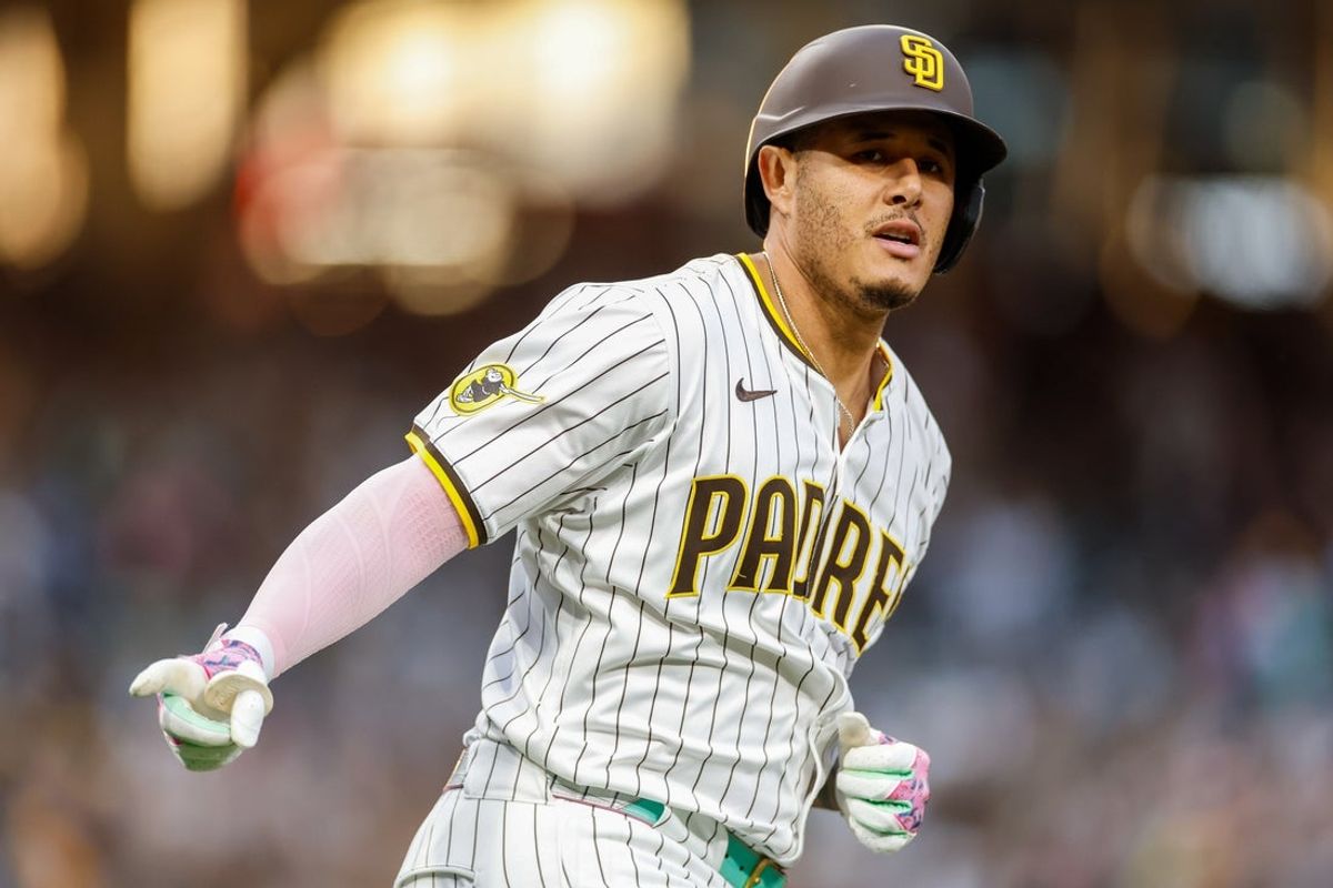 Sep 13, 2025; San Diego, California, USA; San Diego Padres third baseman Manny Machado (13) hits a one run home run during the third inning against the Colorado Rockies at Petco Park. Mandatory Credit: David Frerker-Imagn Images