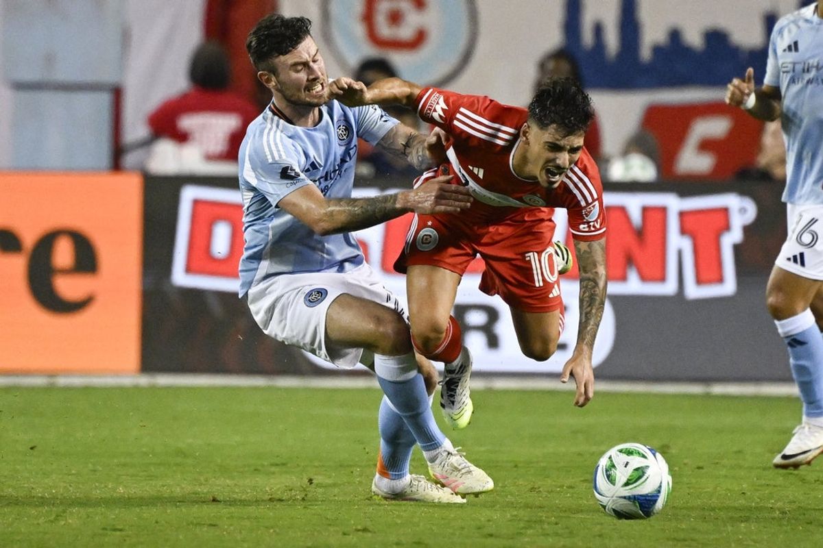 Sep 13, 2025; Chicago, Illinois, USA;  New York City midfielder Aiden O'Neill (21) and Chicago Fire midfielder Andre Franco (10) chase the ball during the first half at Soldier Field. Mandatory Credit: Matt Marton-Imagn Images