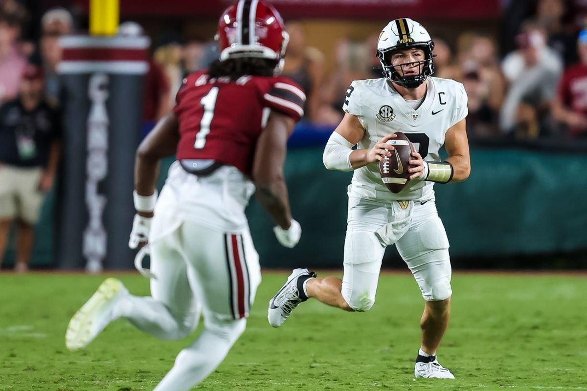 Sep 13, 2025; Columbia, South Carolina, USA; Vanderbilt Commodores quarterback Diego Pavia (2) scrambles against the South Carolina Gamecocks in the second quarter at Williams-Brice Stadium. Mandatory Credit: Jeff Blake-Imagn Images
