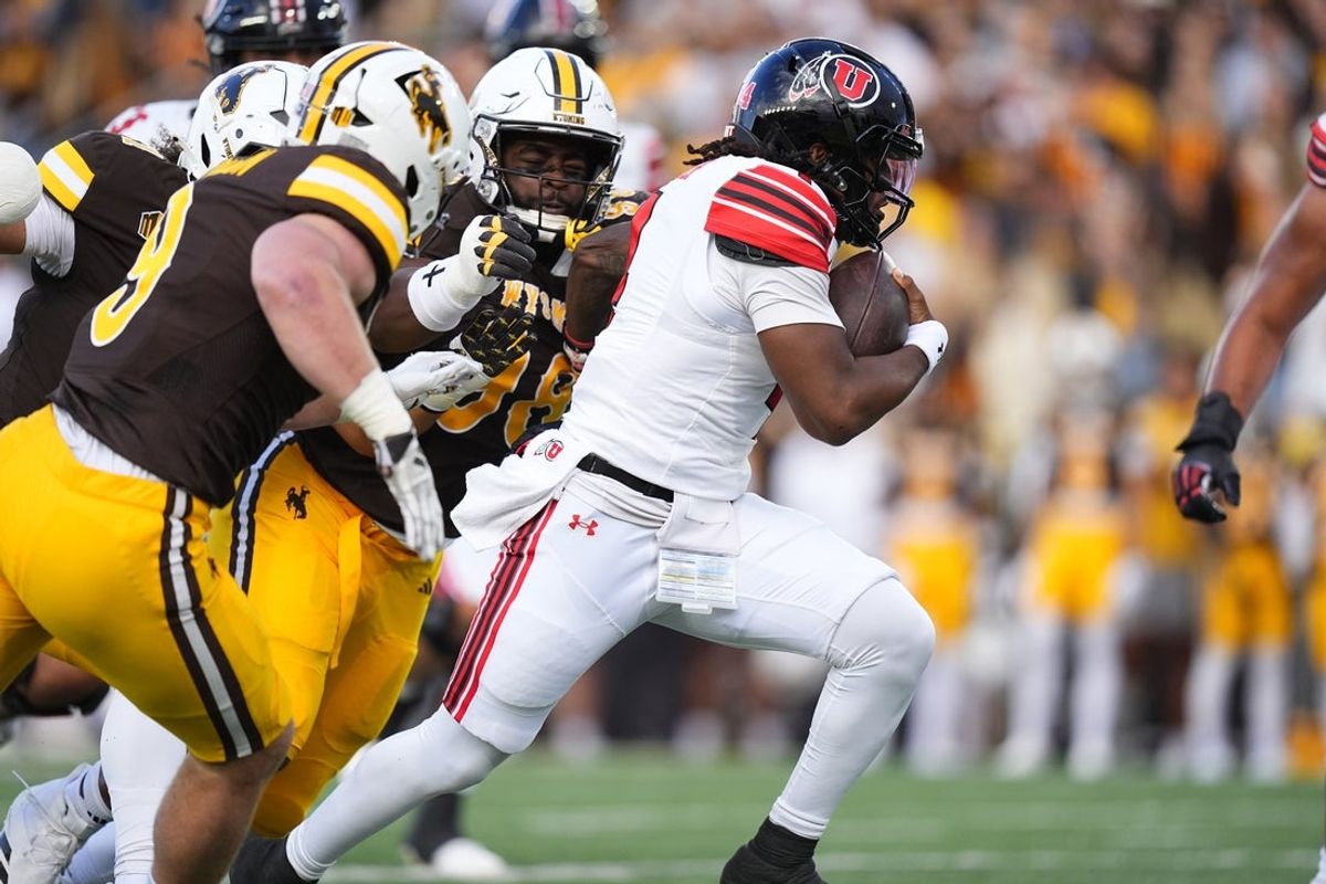 Sep 13, 2025; Laramie, Wyoming, USA; Utah Utes quarterback Devon Dampier (4) carries the ball in the first quarter against the Wyoming Cowboys at Jonah Field at War Memorial Stadium. Mandatory Credit: Ron Chenoy-Imagn Images