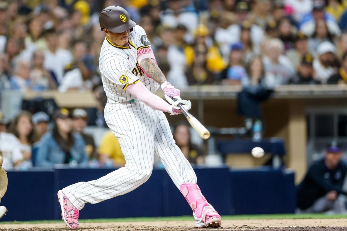Sep 13, 2025; San Diego, California, USA; San Diego Padres third baseman Manny Machado (13) hits a two-run single during the fourth inning against the Colorado Rockies  at Petco Park. Mandatory Credit: David Frerker-Imagn Images