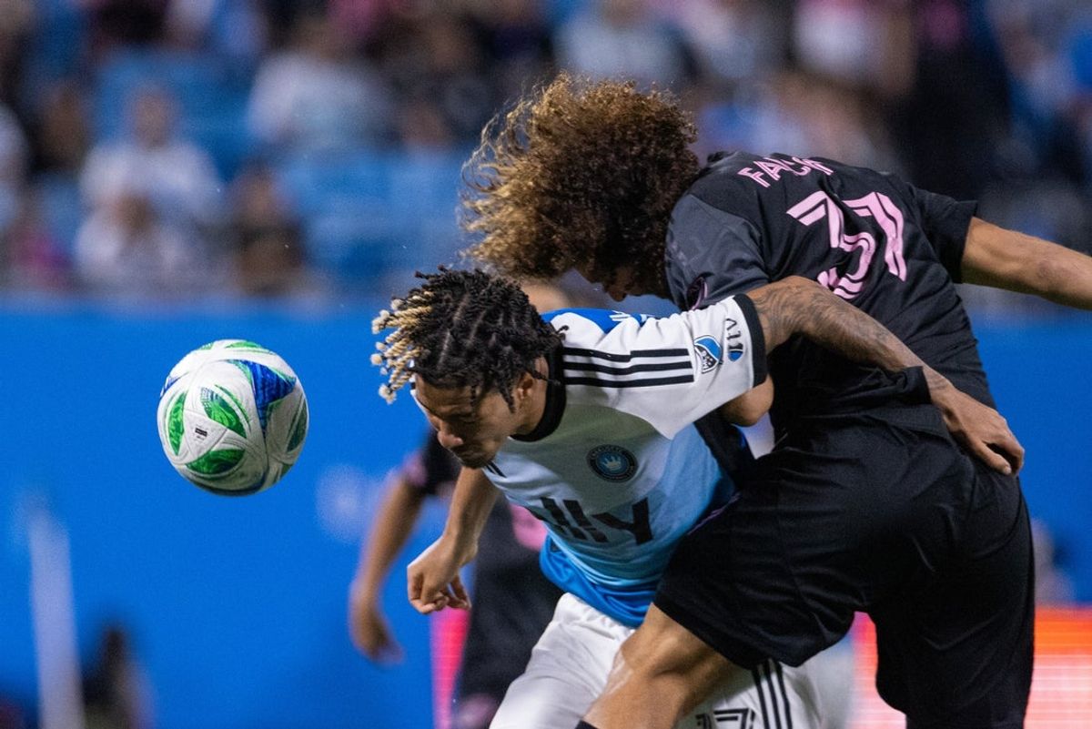 Sep 13, 2025; Charlotte, North Carolina, USA; Charlotte FC forward Idan Toklomati (17) heads the ball past Inter Miami defender Maximiliano Falcón (37) during the second half at Bank of America Stadium. Mandatory Credit: Scott Kinser-Imagn Images