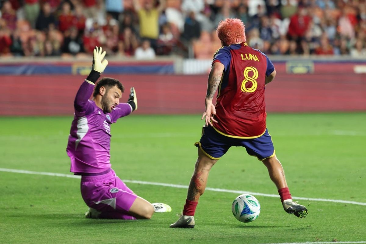 Sep 13, 2025; Sandy, Utah, USA; Real Salt Lake midfielder Diego Luna (8) scores a goal against Sporting Kansas City goalkeeper John Pulskamp (1) during the first half at America First Field. Mandatory Credit: Rob Gray-Imagn Images