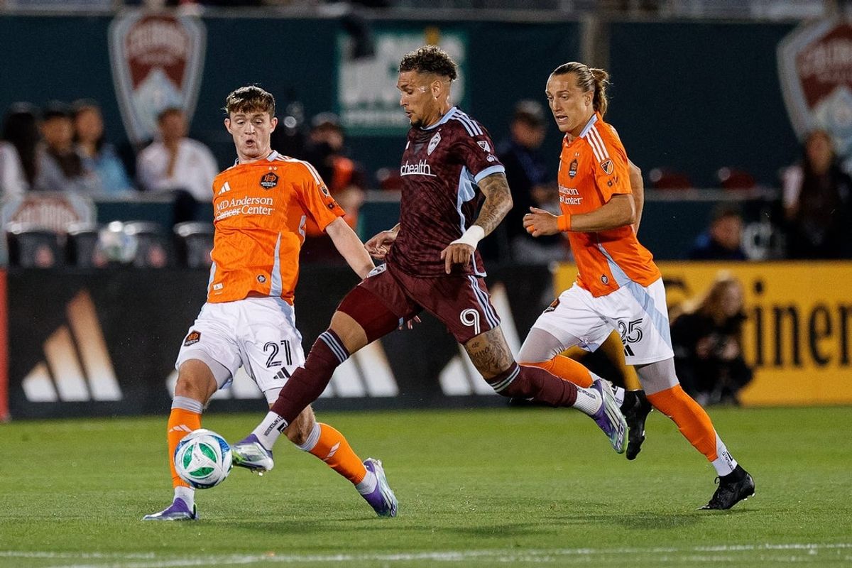 Sep 13, 2025; Commerce City, Colorado, USA; Colorado Rapids forward Rafael Navarro (9) controls the ball against Houston Dynamo FC midfielder Jack McGlynn (21) and midfielder Griffin Dorsey (25) in the first half at Dick's Sporting Goods Park. Mandatory Credit: Isaiah J. Downing-Imagn Images