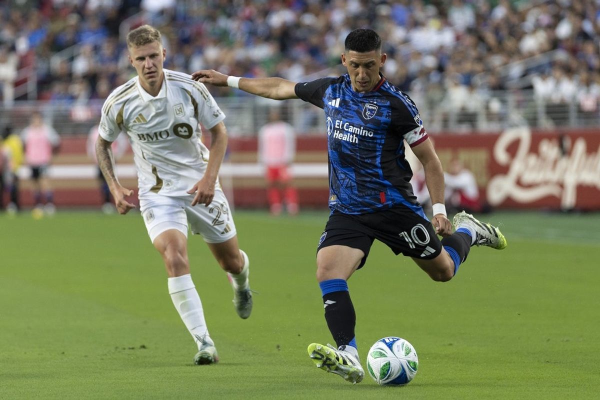 Sep 13, 2025; Santa Clara, California, USA;  San Jose Earthquakes forward Cristian Espinoza (10) kicks the ball during the second half against Los Angeles FC defender Artem Smolyakov (29) at Levi's Stadium. Mandatory Credit: Stan Szeto-Imagn Images