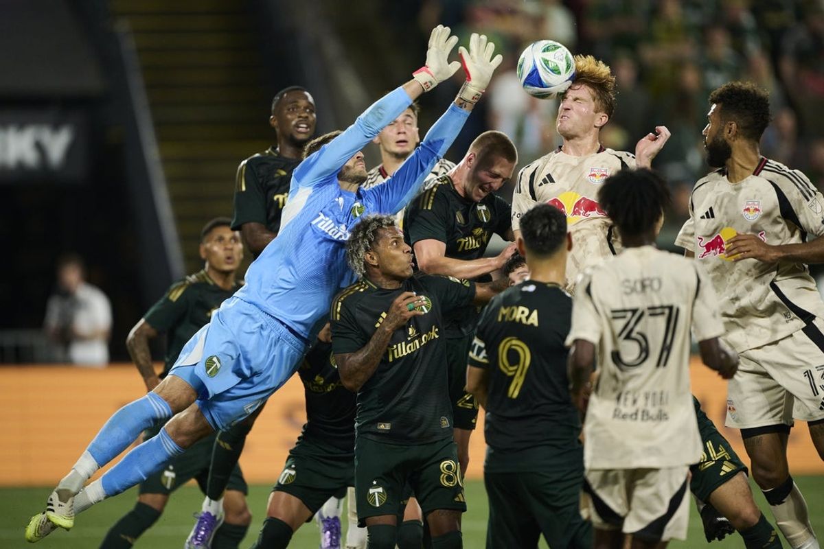 Sep 13, 2025; Portland, Oregon, USA; New York Red Bulls defender Tim Parker (26) heads the ball during the first half on a corner kick against Portland Timbers goalkeeper James Pantemis (41) at Providence Park. Mandatory Credit: Troy Wayrynen-Imagn Images