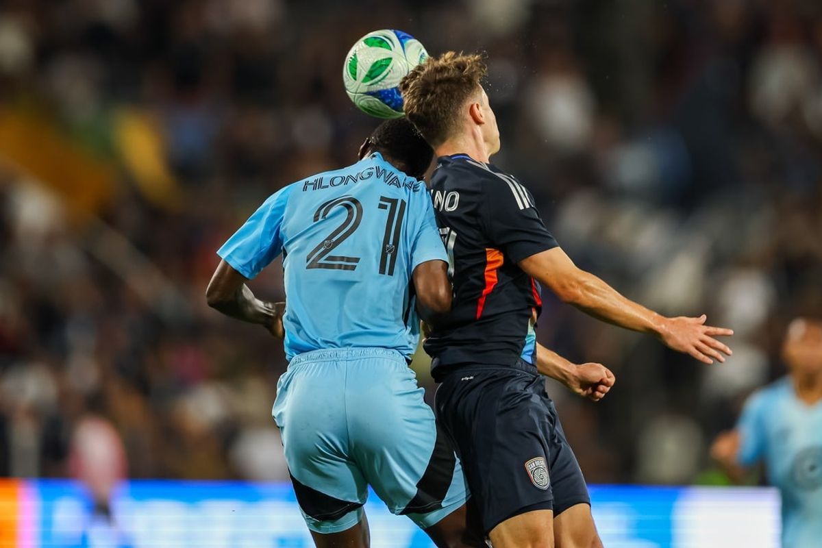 Sep 13, 2025; San Diego, California, USA; San Diego FC defender Luca Bombino (27) heads the ball against Minnesota United forward Bongokuhle Hlongwane (21) during the first half at Snapdragon Stadium. Mandatory Credit: Chadd Cady-Imagn Images