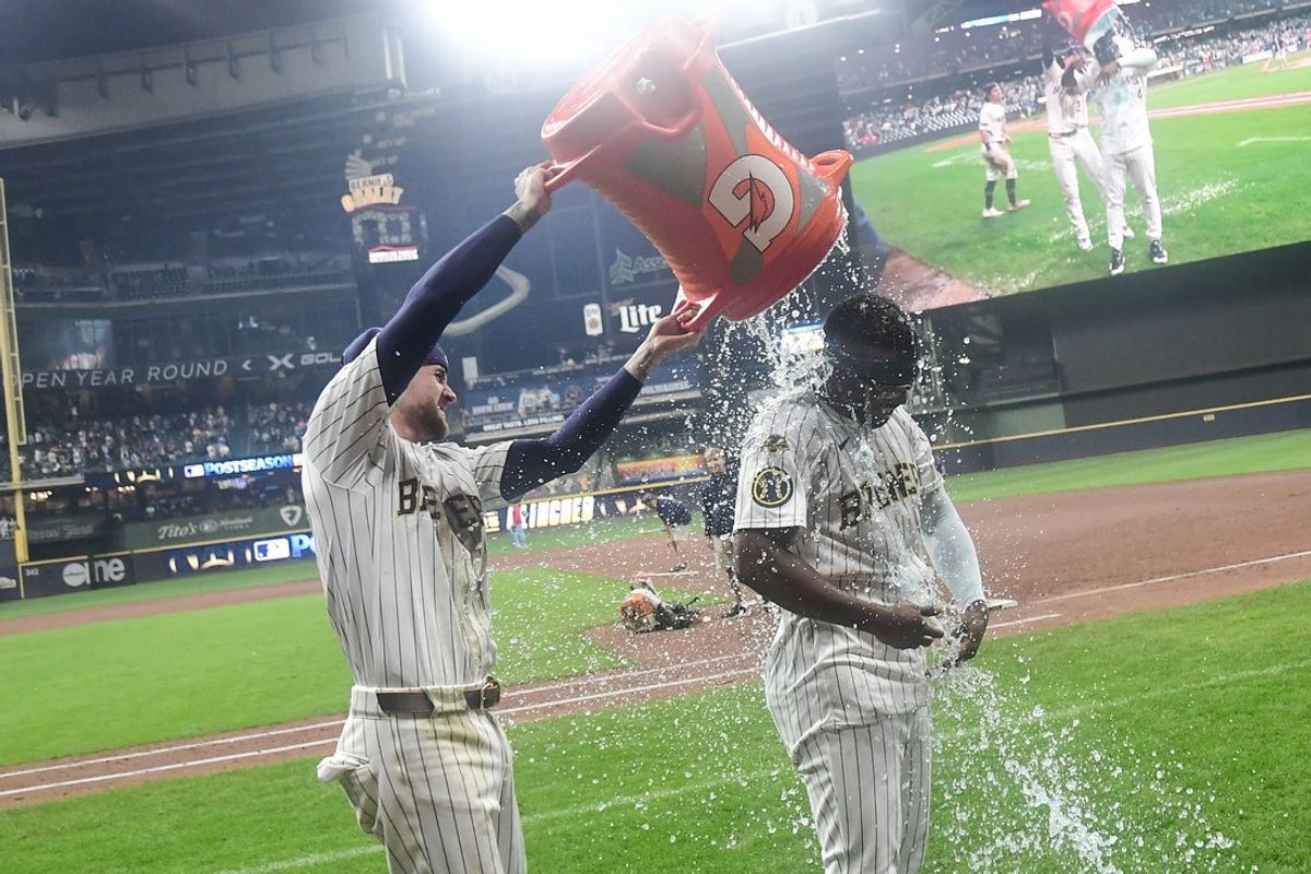 Sep 13, 2025; Milwaukee, Wisconsin, USA;  Milwaukee Brewers second baseman Andruw Monasterio (14) is dunked by second baseman Brice Turang (2) after beating the St. Louis Cardinals in the tenth inning at American Family Field. Mandatory Credit: Benny Sieu-Imagn Images