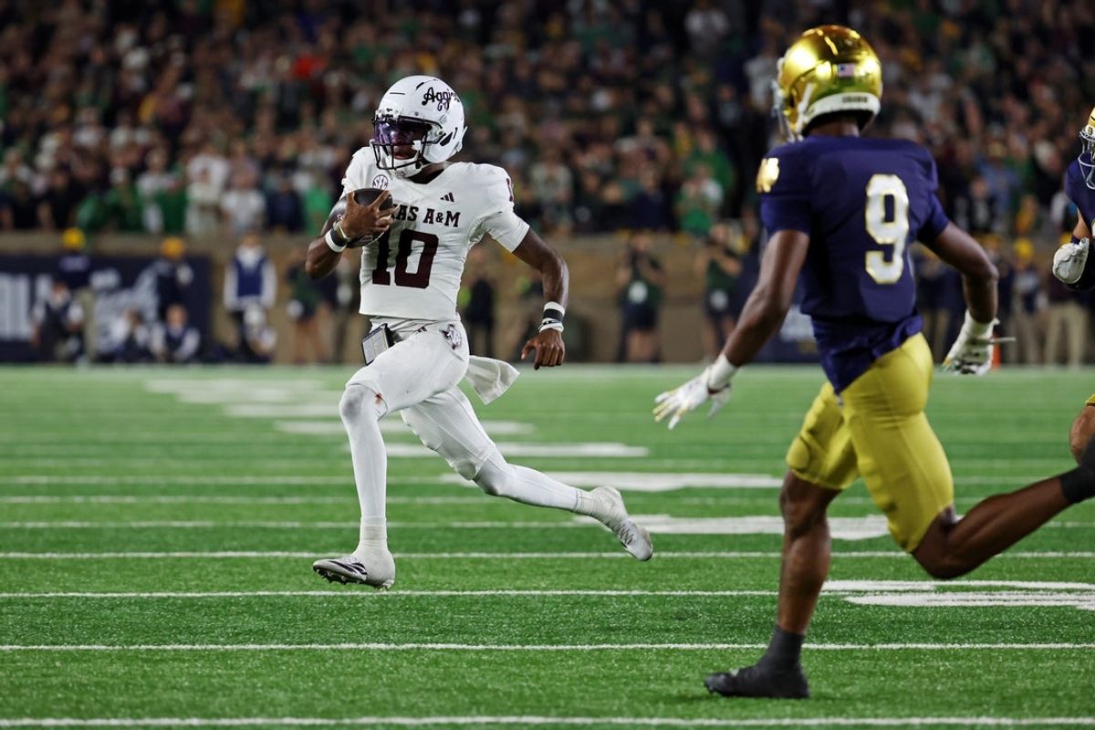 Sep 13, 2025; South Bend, Indiana, USA; Texas A&M Aggies quarterback Marcel Reed (10) runs the ball as Notre Dame Fighting Irish safety Tae Johnson (9) defends during the second half at Notre Dame Stadium. Mandatory Credit: Trevor Ruszkowski-Imagn Images