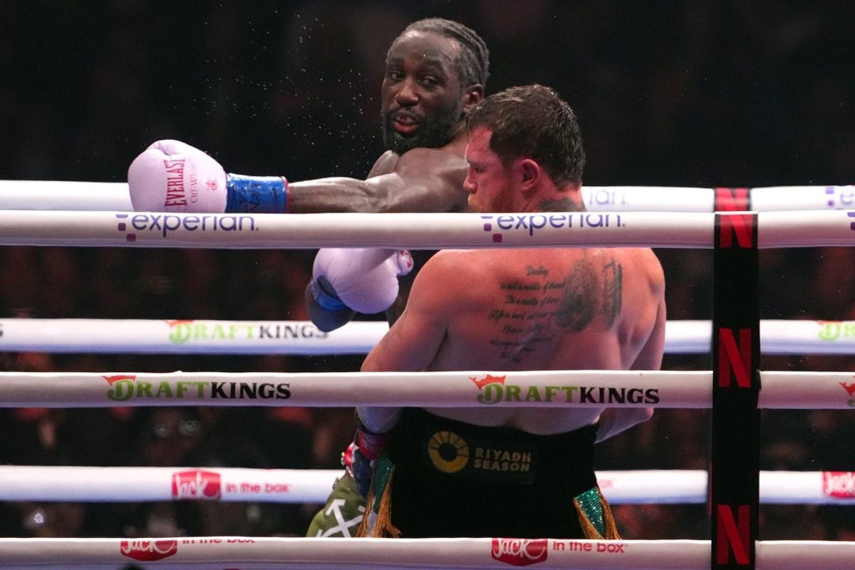 Sep 13, 2025; Las Vegas, Nevada, USA; Canelo Alvarez (black/gold trunks) and Terence Crawford (black/red trunks) box during their super middleweight title bout  at Allegiant Stadium. Mandatory Credit: Joe Camporeale-Imagn Images