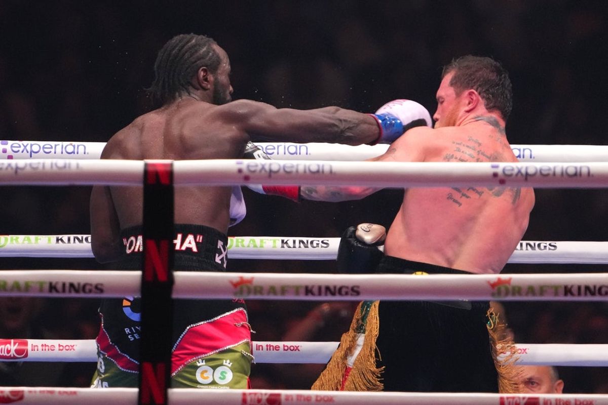 Sep 13, 2025; Las Vegas, Nevada, USA; Canelo Alvarez (black/gold trunks) and Terence Crawford (black/red trunks) box during their super middleweight title bout at Allegiant Stadium. Mandatory Credit: Joe Camporeale-Imagn Images