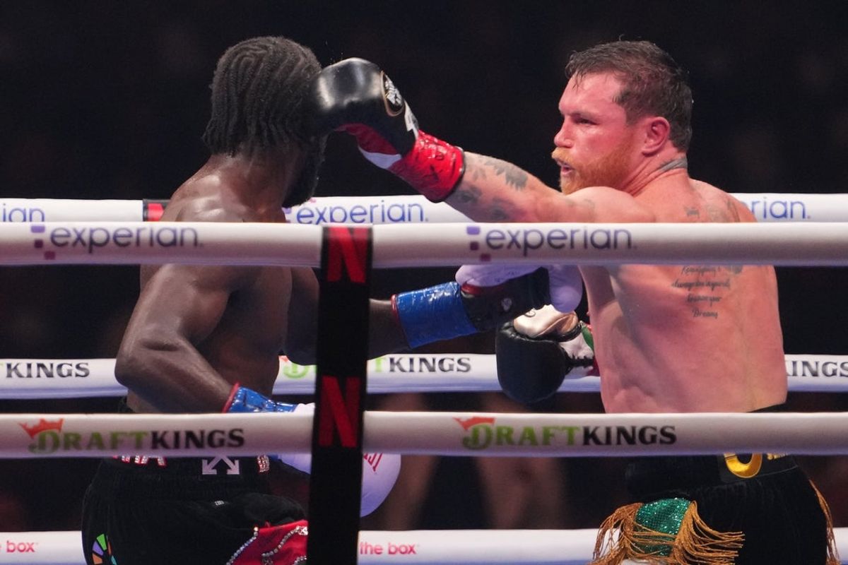 Sep 13, 2025; Las Vegas, Nevada, USA; Canelo Alvarez (black/gold trunks) and Terence Crawford (black/red trunks) box during their super middleweight title bout at Allegiant Stadium. Mandatory Credit: Joe Camporeale-Imagn Images
