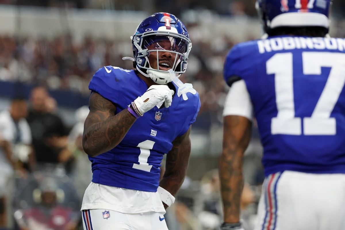 Sep 14, 2025; Arlington, Texas, USA; New York Giants wide receiver Malik Nabers (1) celebrates after scoring a touchdown against the Dallas Cowboys during the second quarter at AT&T Stadium. Mandatory Credit: Kevin Jairaj-Imagn Images