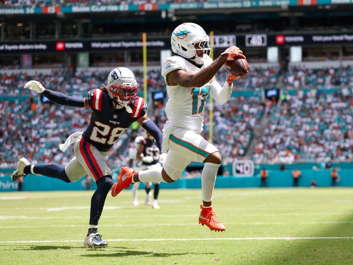 Sep 14, 2025; Miami Gardens, Florida, USA; Miami Dolphins wide receiver Jaylen Waddle (17) catches a pass for a touchdown defended by New England Patriots cornerback Alex Austin (28) in the second quarter  at Hard Rock Stadium. Mandatory Credit: Nathan Ray Seebeck-Imagn Images