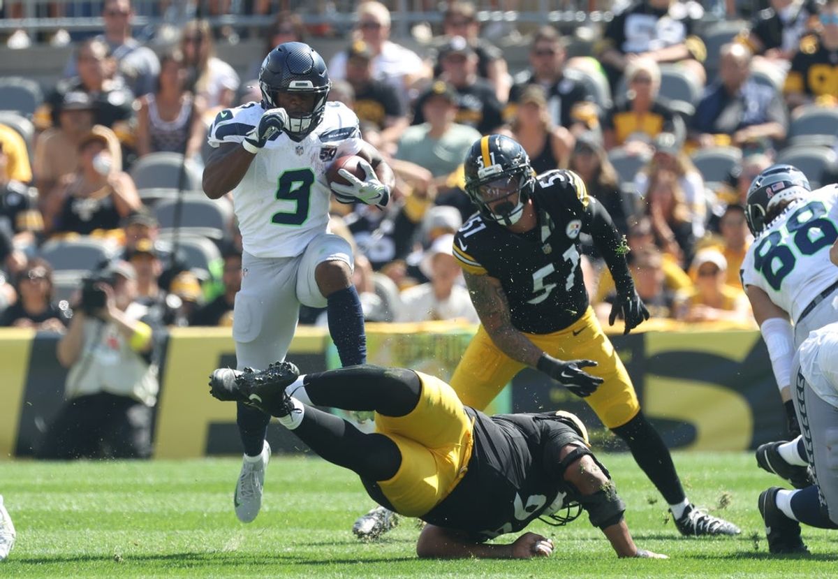 Sep 14, 2025; Pittsburgh, Pennsylvania, USA;  Seattle Seahawks running back Kenneth Walker III (9) leaps over Pittsburgh Steelers defensive tackle Yaha Black (bottom) on a second quarter carry at Acrisure Stadium. Mandatory Credit: Charles LeClaire-Imagn Images
