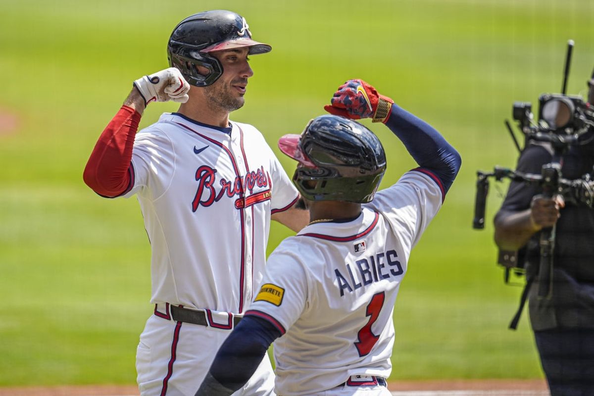 Sep 14, 2025; Cumberland, Georgia, USA; Atlanta Braves first baseman Matt Olson (28) reacts with second baseman Ozzie Albies (1) after hitting a home run against the Houston Astros during the first inning at Truist Park. Mandatory Credit: Dale Zanine-Imagn Images