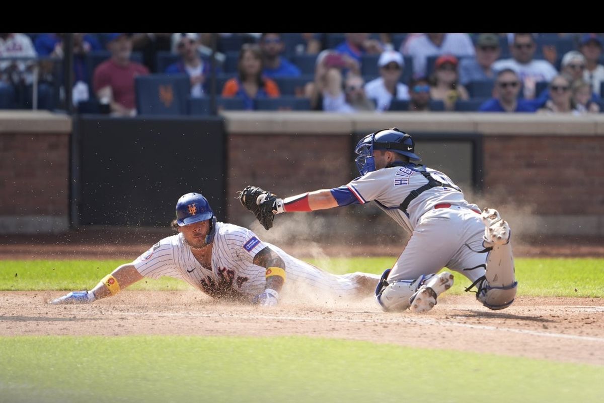 Sep 14, 2025; New York City, New York, USA; New York Mets catcher Francisco Alvarez (4) slides safely into home plate ahead of the tag by Texas Rangers catcher Kyle Higashioka (11) during the fifth inning at Citi Field. Mandatory Credit: Gregory Fisher-Imagn Images