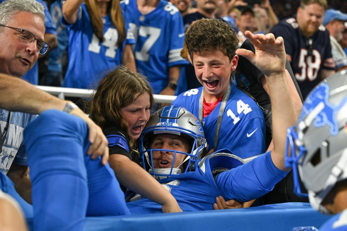 Sep 14, 2025; Detroit, Michigan, USA; Detroit Lions quarterback Jared Goff (16) leaps into the crowd after a touchdown against the Chicago Bears during the fourth quarter of the game at Ford Field. Mandatory Credit: Lon Horwedel-Imagn Images