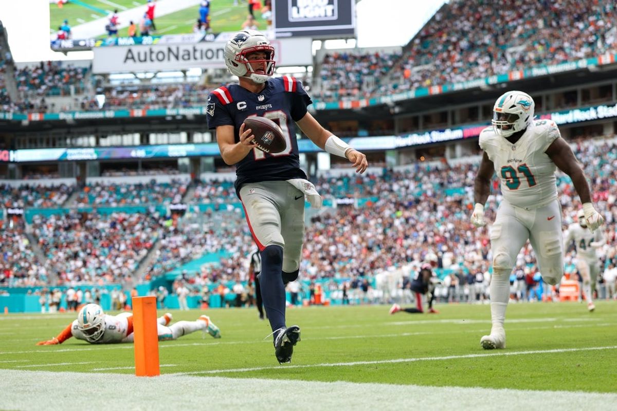 Sep 14, 2025; Miami Gardens, Florida, USA; New England Patriots quarterback Drake Maye (10) runs into the endzone for a touchdown against the Miami Dolphins in the third quarter at Hard Rock Stadium. Mandatory Credit: Nathan Ray Seebeck-Imagn Images