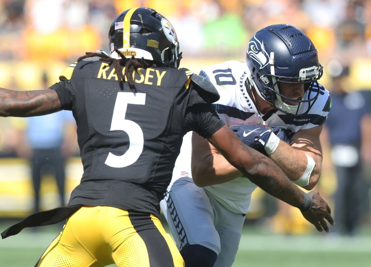 Sep 14, 2025; Pittsburgh, Pennsylvania, USA;  Seattle Seahawks wide receiver Cooper Kupp (10) runs after a catch as Pittsburgh Steelers cornerback Jalen Ramsey (5) defends during the third quarter at Acrisure Stadium. Mandatory Credit: Charles LeClaire-Imagn Images