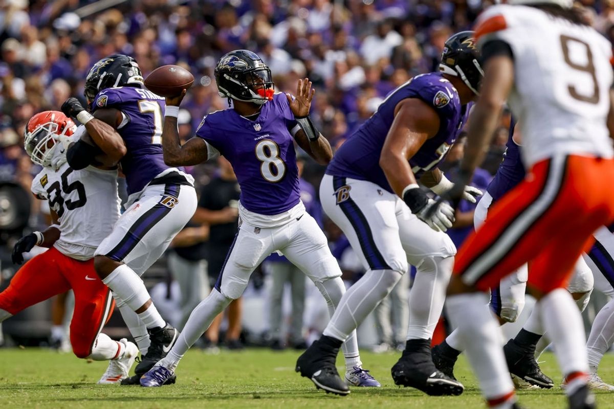 Sep 14, 2025; Baltimore, Maryland, USA; Baltimore Ravens quarterback Lamar Jackson (8) throws a touchdown pass during the fourth quarter at M&T Bank Stadium. Mandatory Credit: Peter Casey-Imagn Images