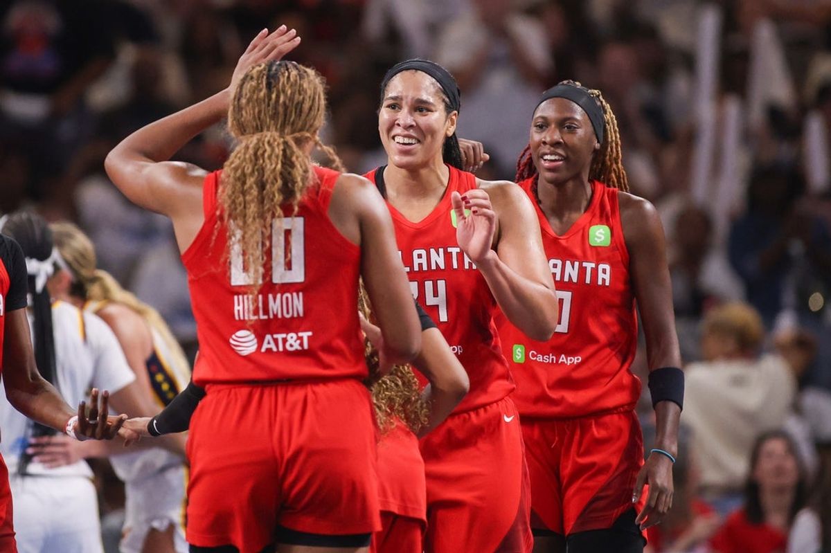 Sep 14, 2025; College Park, Georgia, USA; Atlanta Dream forward Naz Hillmon (00) and forward Brionna Jones (24) and guard Rhyne Howard (10) react after a basket against the Indiana Fever in the fourth quarter during game one of round one for the 2025 WNBA Playoffs at Gateway Center Arena at College Park. Mandatory Credit: Brett Davis-Imagn Images