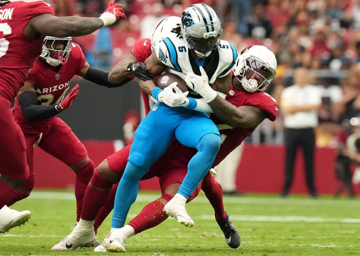 Arizona Cardinals linebacker Jordan Burch (52) tackles Carolina Panthers running back Rico Dowdle (5) at State Farm Stadium on Sept 14, 2025.