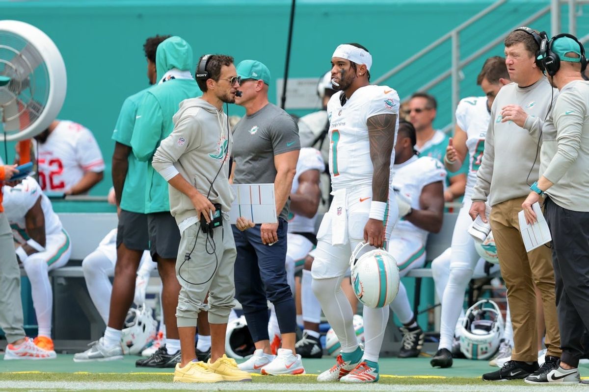 Sep 14, 2025; Miami Gardens, Florida, USA;Miami Dolphins head coach Mike McDaniel and quarterback Tua Tagovailoa (1) stand on the sideline against the New England Patriots during the second quarter at Hard Rock Stadium. Mandatory Credit: Sam Navarro-Imagn Images