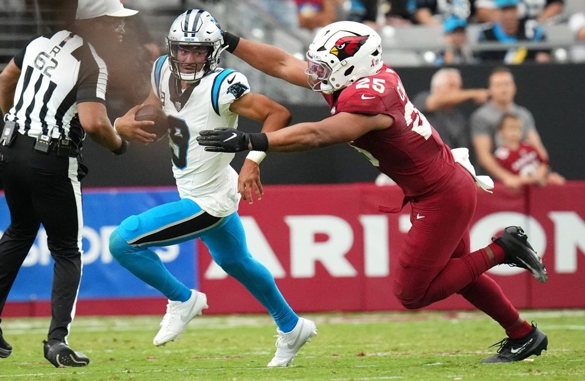 Arizona Cardinals linebacker Zaven Collins (25) chases down Carolina Panthers quarterback Bryce Young (9) at State Farm Stadium on Sept 14, 2025.