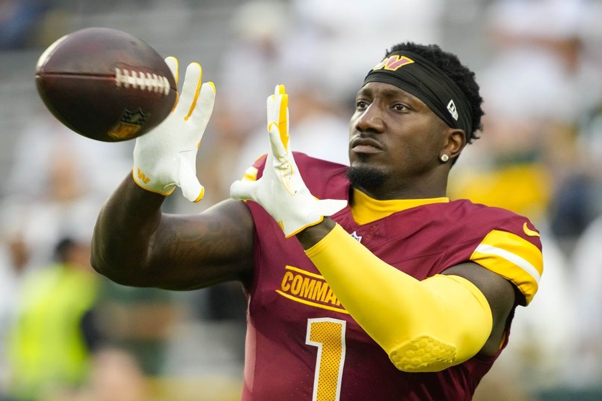 Sep 11, 2025; Green Bay, Wisconsin, USA;  Washington Commanders wide receiver Deebo Samuel Sr. (1) catches a pass during warmups prior to the game against the Green Bay Packers at Lambeau Field. Mandatory Credit: Jeff Hanisch-Imagn Images