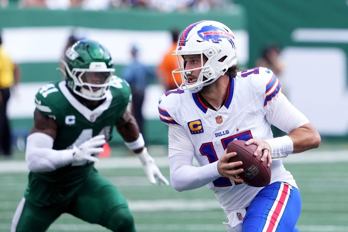 Sep 14, 2025; East Rutherford, New Jersey, USA; Buffalo Bills quarterback Josh Allen (17) rushes the ball past New York Jets linebacker Marcelino McCrary-Ball (41) during the first half at MetLife Stadium. Mandatory Credit: Robert Deutsch-Imagn Images