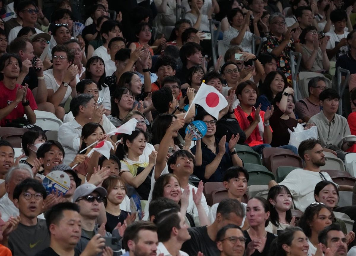 Sep 15, 2025; Tokyo, Japan; A Japanese fan waves a flag during World Athletics Championships at National Stadium. Mandatory Credit: Kirby Lee-Imagn Images