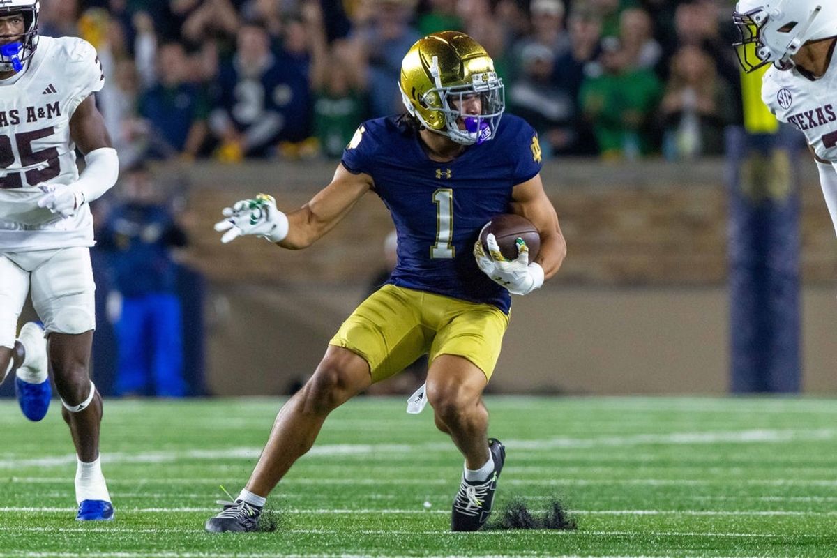 Sep 13, 2025; South Bend, Indiana, USA; Notre Dame Fighting Irish wide receiver Jaden Greathouse (1) runs with the ball during the second half against the Texas A&M Aggies at Notre Dame Stadium. Mandatory Credit: Michael Caterina-Imagn Images