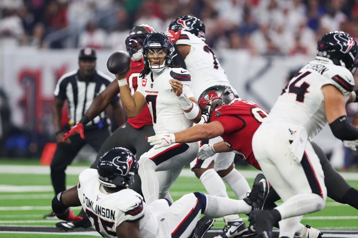 Sep 15, 2025; Houston, Texas, USA; Houston Texans quarterback C.J. Stroud (7) comes under pressure from Tampa Bay Buccaneers defensive tackle Greg Gaines (96) during the second quarter at NRG Stadium. Mandatory Credit: Troy Taormina-Imagn Images