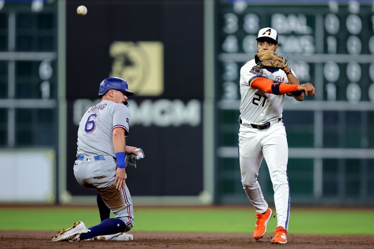Sep 15, 2025; Houston, Texas, USA; Houston Astros shortstop Jeremy Pena (3) throws a fielded ball to first base to complete a double play against the Texas Rangers during the third inning at Daikin Park. Mandatory Credit: Erik Williams-Imagn Images