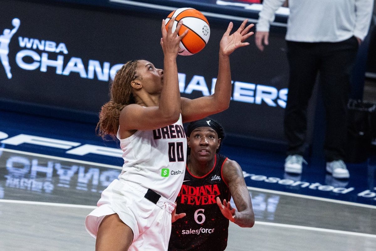 Sep 16, 2025; Indianapolis, Indiana, USA;  Atlanta Dream forward Naz Hillmon (00) shoots the ball while Indiana Fever forward Natasha Howard (6) defends during game two of round one for the 2025 WNBA Playoffs at Gainbridge Fieldhouse. Mandatory Credit: Trevor Ruszkowski-Imagn Images