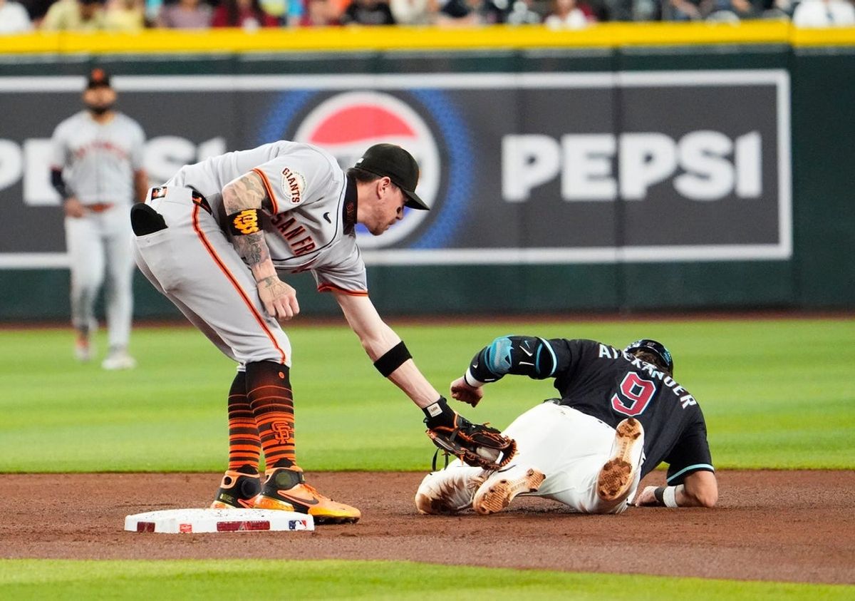 San Francisco Giants second base Christian Koss (50) tags out Arizona Diamondbacks Blaze Alexander (9) in the second inning at Chase Field in Phoenix on Sept. 17, 2025.
