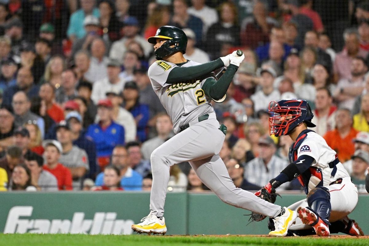 Sep 17, 2025; Boston, Massachusetts, USA; Athletics second baseman Darell Hernaiz (2) hits a one run RBI against the Boston Red Sox during the second inning at Fenway Park. Mandatory Credit: Eric Canha-Imagn Images