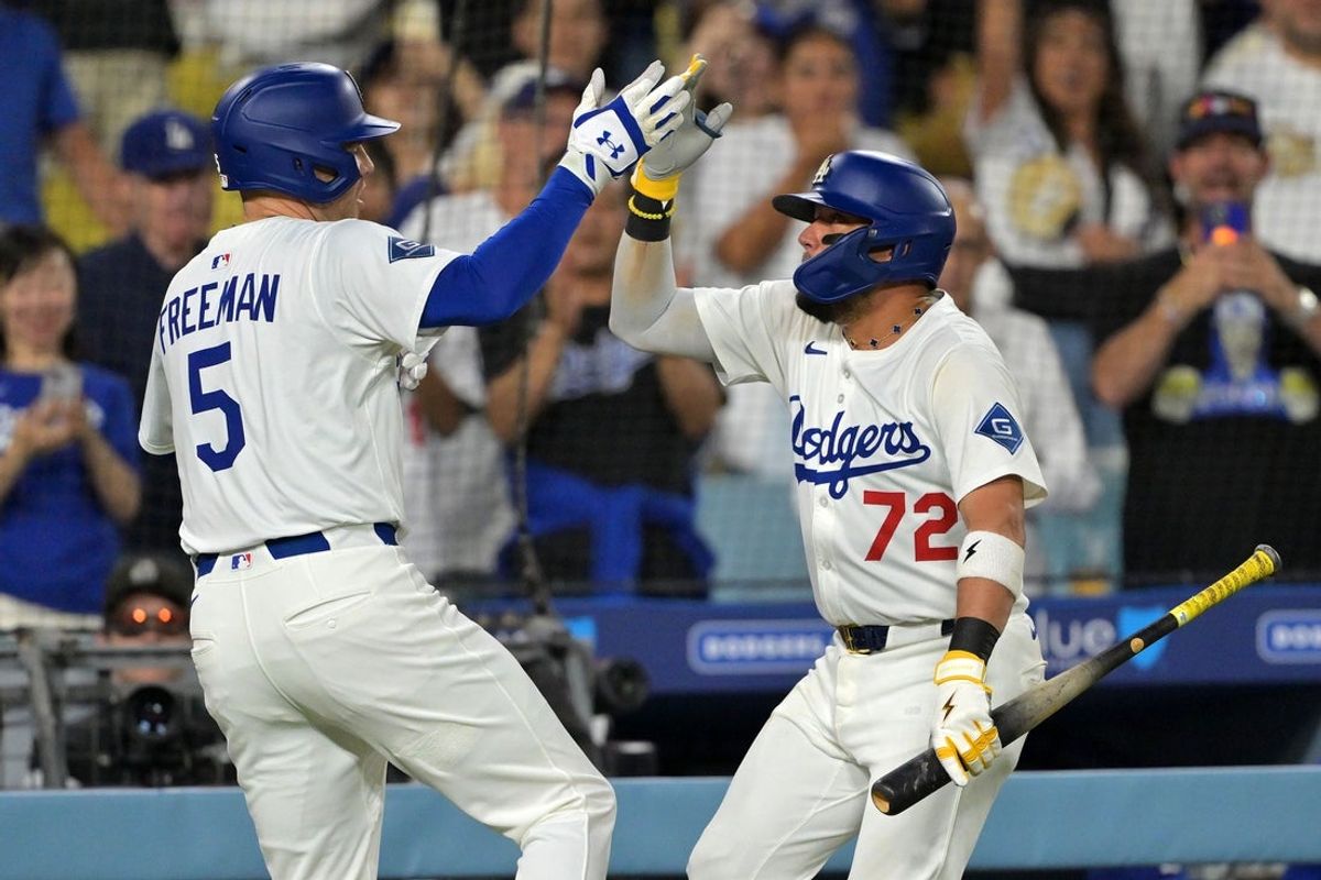 Sep 17, 2025; Los Angeles, California, USA; Los Angeles Dodgers first base Freddie Freeman (5) reacts with second base Miguel Rojas (72) after hitting a home run against the Philadelphia Phillies in the second inning at Dodger Stadium. Mandatory Credit: Jayne Kamin-Oncea-Imagn Images