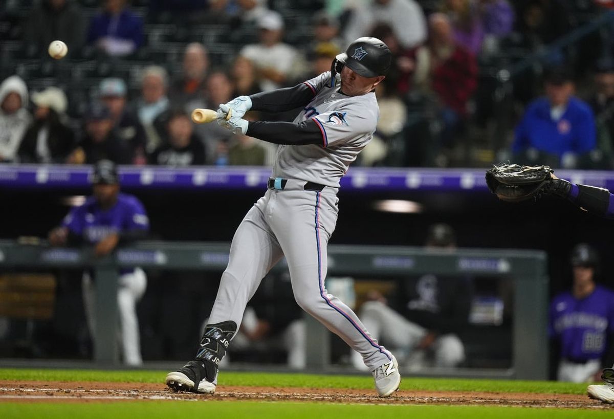 Sep 17, 2025; Denver, Colorado, USA; Miami Marlins right fielder Troy Johnston (75) singles in the fourth inning against the Colorado Rockies at Coors Field. Mandatory Credit: Ron Chenoy-Imagn Images