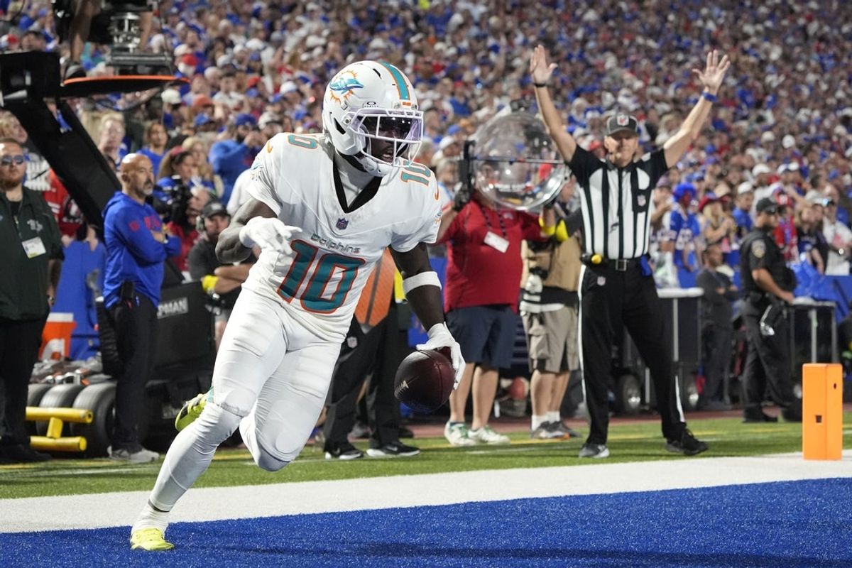 Sep 18, 2025; Orchard Park, New York, USA;  Miami Dolphins wide receiver Tyreek Hill (10) scores a touchdown against the Buffalo Bills in the fourth quarter at Highmark Stadium. Mandatory Credit: Gregory Fisher-Imagn Images