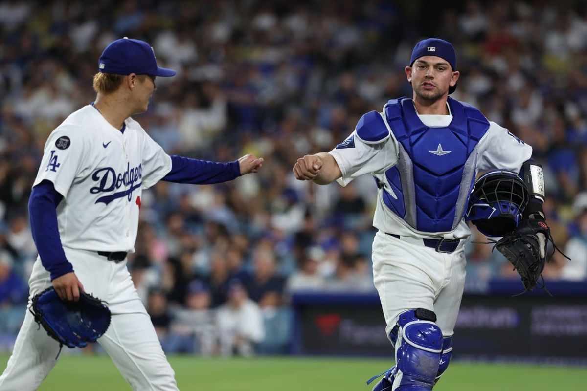 Sep 18, 2025; Los Angeles, California, USA;  Los Angeles Dodgers pitcher Yoshinobu Yamamoto (18) and catcher Ben Rortvedt (47) react after the second inning against the San Francisco Giants  at Dodger Stadium. Mandatory Credit: Kiyoshi Mio-Imagn Images