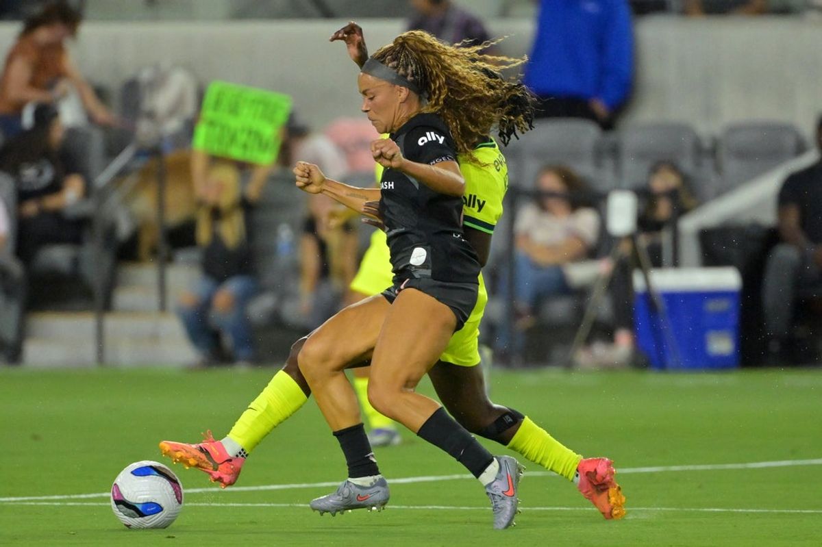 Sep 18, 2025; Los Angeles, California, USA;  Angel City FC defender Sarah Gorden (11) and Washington Spirit forward Rosemonde Kouassi (19) battle for the ball during the first half at BMO Stadium. Mandatory Credit: Jayne Kamin-Oncea-Imagn Images