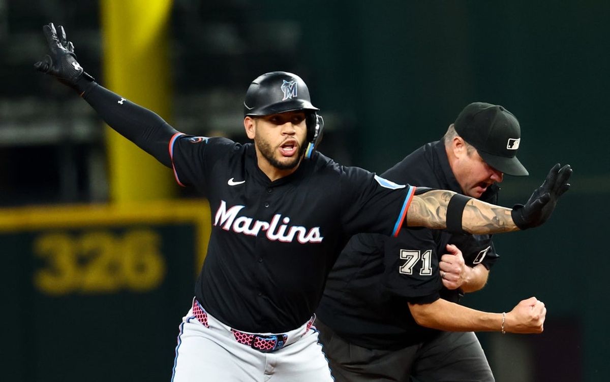 Sep 19, 2025; Arlington, Texas, USA;  Miami Marlins designated hitter Agustin Ramirez (50) is initially called out at second base by umpire Jordan Baker (71) but had the call overturned during the third inning against the Texas Rangers at Globe Life Field. Mandatory Credit: Kevin Jairaj-Imagn Images