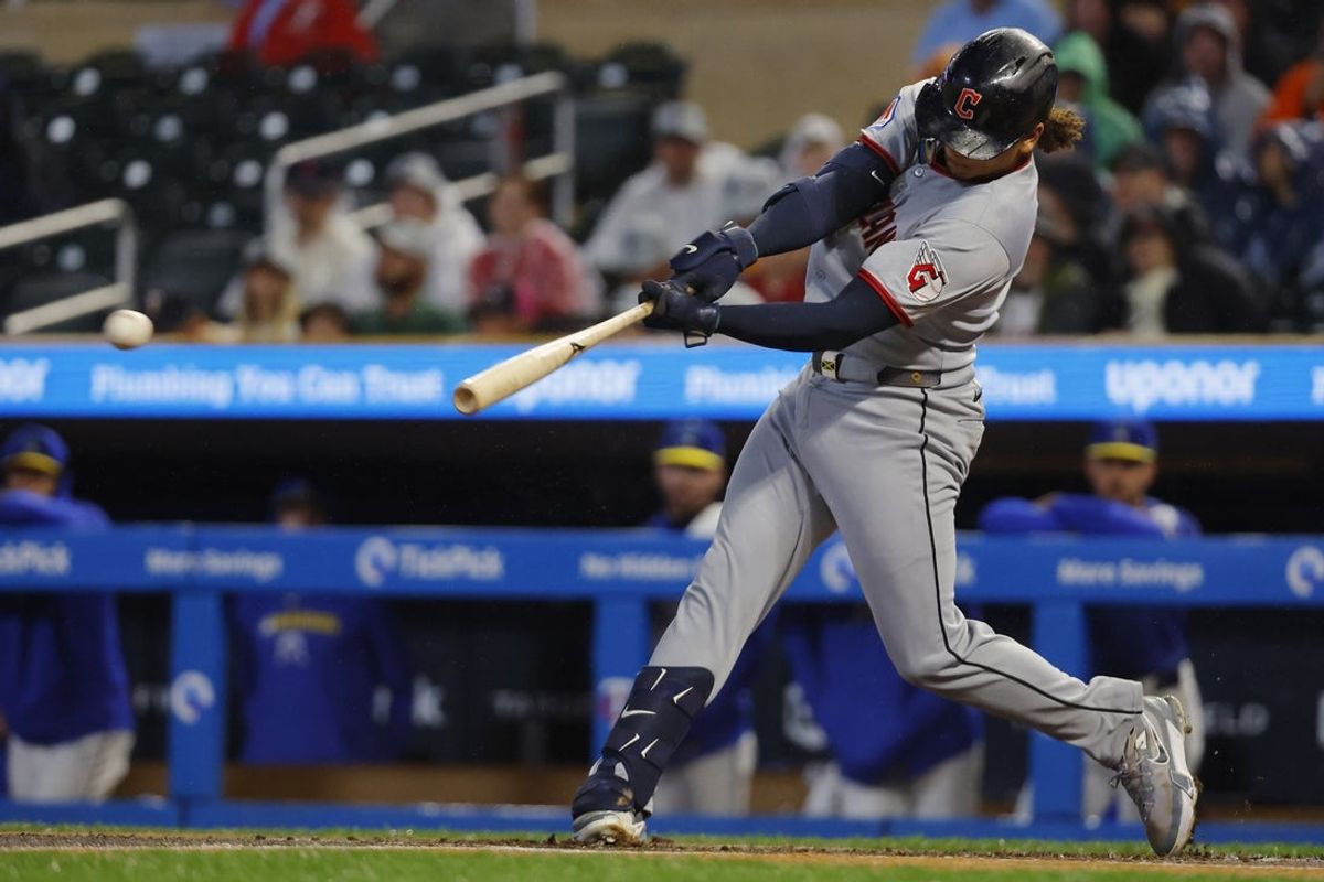 Sep 19, 2025; Minneapolis, Minnesota, USA; Cleveland Guardians catcher Bo Naylor (23) hits a two-run single against the Minnesota Twins in the first inning at Target Field. Mandatory Credit: Bruce Kluckhohn-Imagn Images