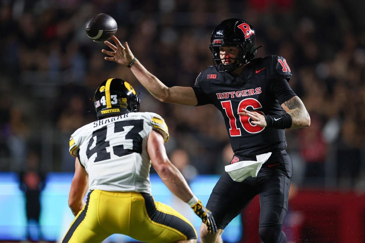 Sep 19, 2025; Piscataway, New Jersey, USA; Rutgers Scarlet Knights quarterback Athan Kaliakmanis (16) passes the ball during the first half as Iowa Hawkeyes linebacker Karson Sharar (43) defends at SHI Stadium. Mandatory Credit: Vincent Carchietta-Imagn Images