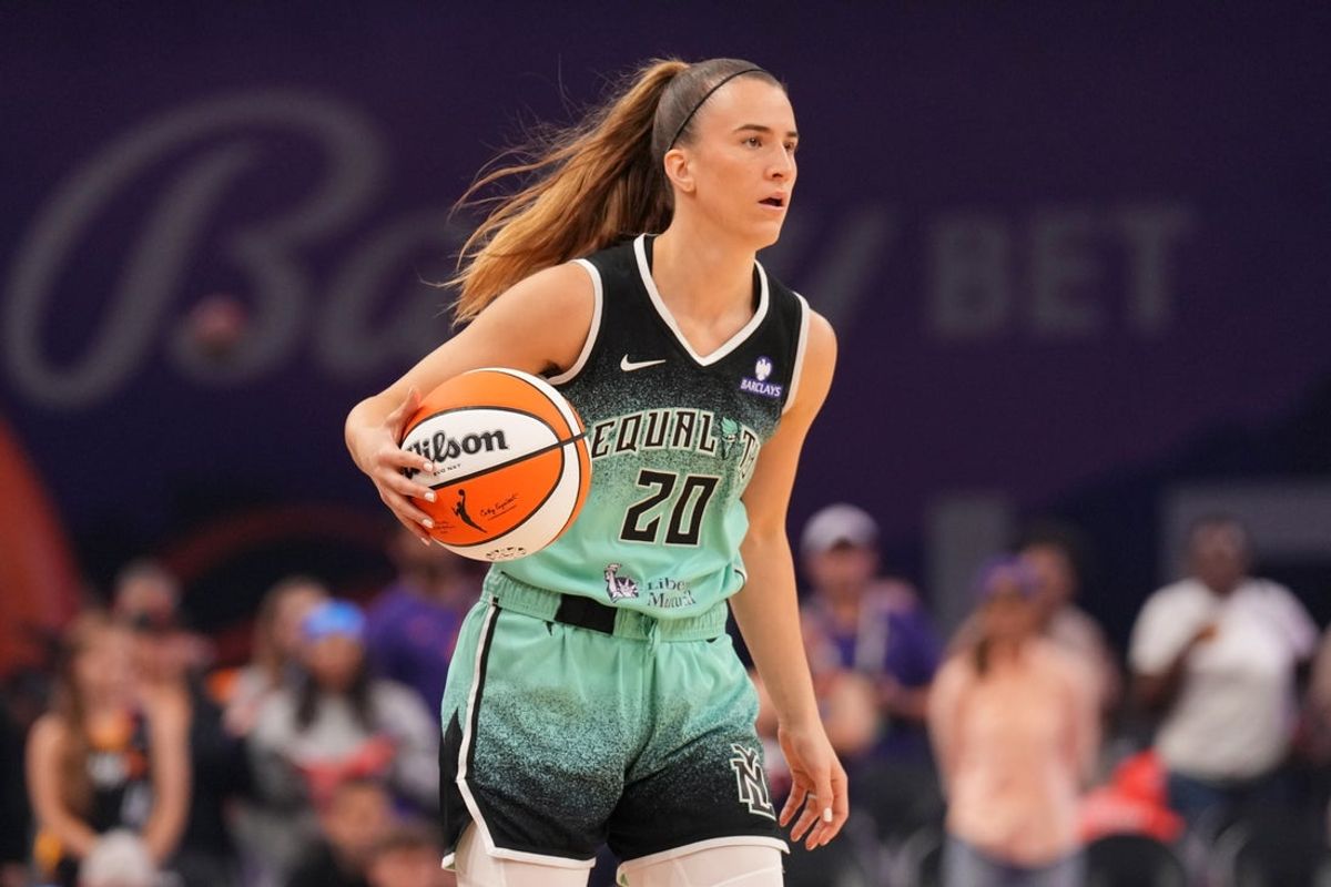 Sep 19, 2025; Phoenix, Arizona, USA; New York Liberty guard Sabrina Ionescu (20) dribbles against the Phoenix Mercury during the first half of game three of round one for the 2025 WNBA Playoffs at PHX Arena. Mandatory Credit: Joe Camporeale-Imagn Images