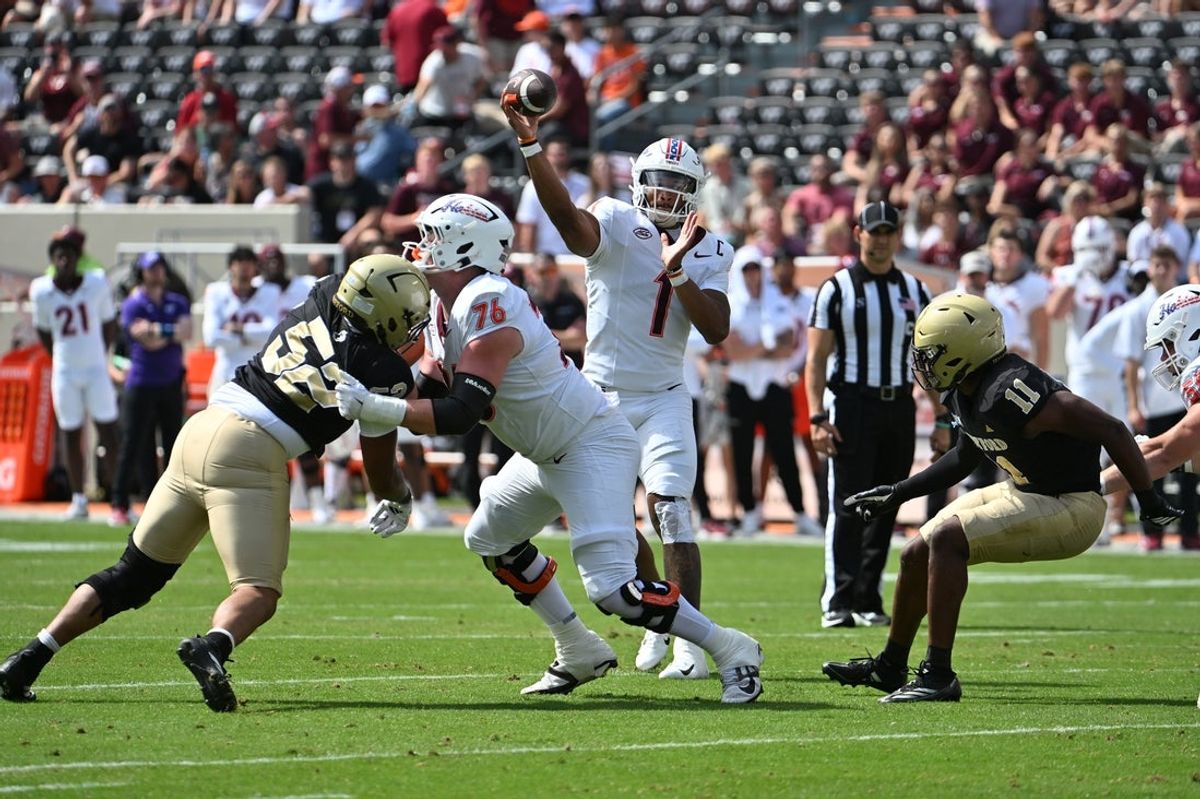 Sep 20, 2025; Blacksburg, Virginia, USA;  Virginia Tech Hokies quarterback Kyron Drones (1) throws a pass as Virginia Tech Hokies offensive lineman Aidan Lynch (76) blacks during the first quarter at Lane Stadium. Mandatory Credit: Brian Bishop-Imagn Images