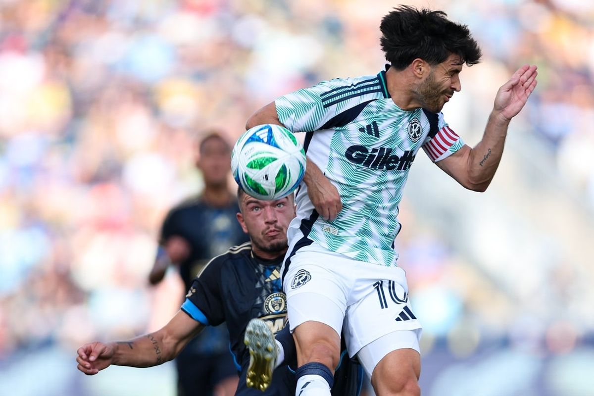 Sep 20, 2025; Chester, Pennsylvania, USA; Philadelphia Union defender Kai Wagner (27) kicks the ball behind New England Revolution Carles Gil (10) during the first half at Subaru Park. Mandatory Credit: Bill Streicher-Imagn Images